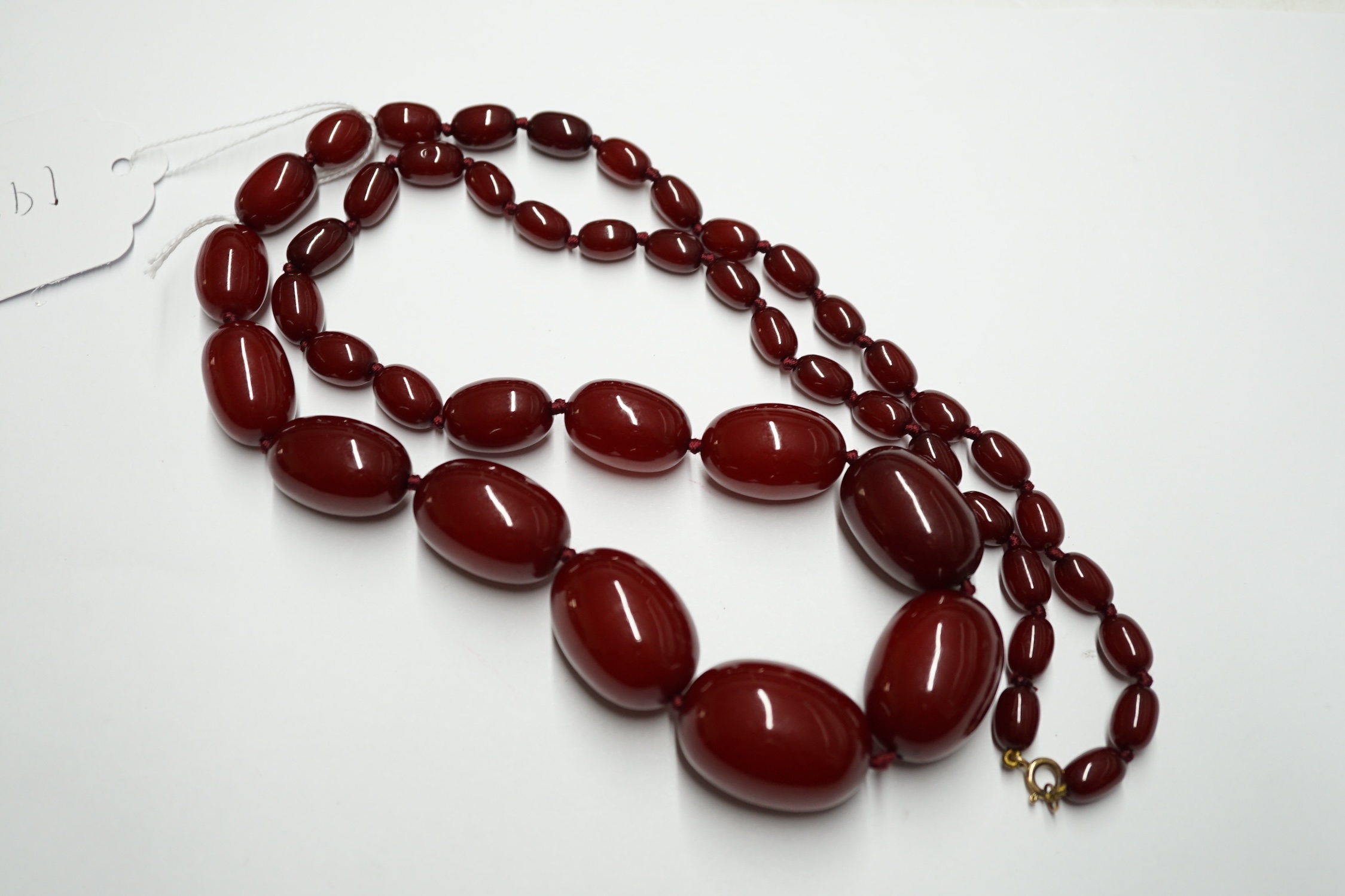 A single strand graduated simulated cherry amber bead necklace, 78cm, gross weight 87 grams. Condition - fair